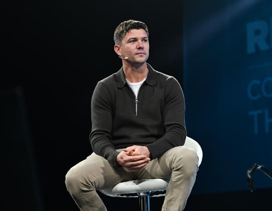 Luke Campbell seated on a white stool