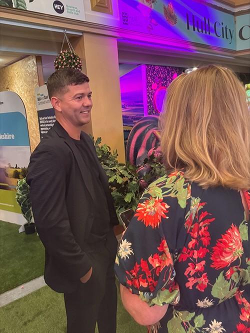 Mayor Luke Campbell speaking with a business attendee