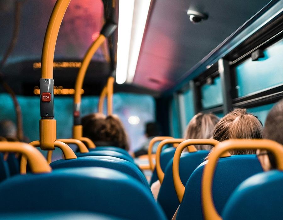 People sat facing forward travelling on a bus